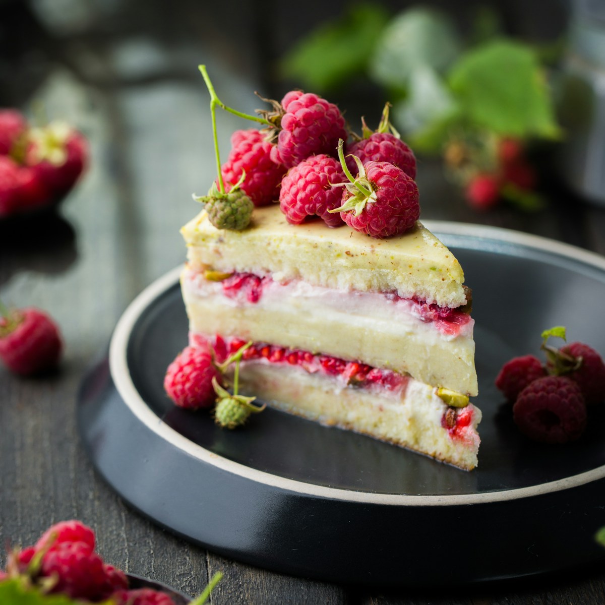 Layered raspberry dessert served on a dark plate